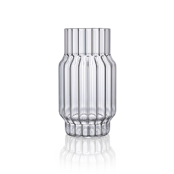 Clear, fluted vase in glass for flowers in home decor.
