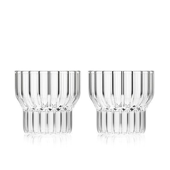 A set of two clear, low, small, fluted drinking glasses by contemporary designer, Felicia Ferrone. 