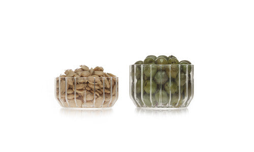 Modern glass bowls in fluted glass filled with nuts and olives by designer Felicia Ferrone. 