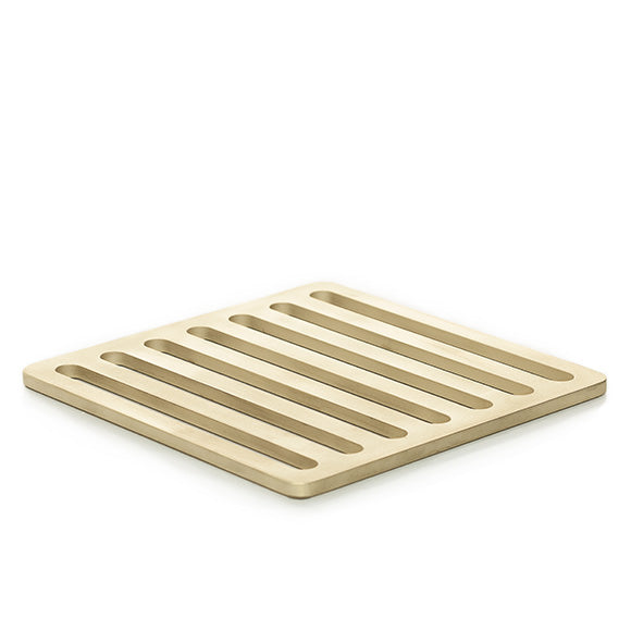 Designer trivet inspired by the streets of Milan, Italy, and made of solid brass with a sandblasted finish.