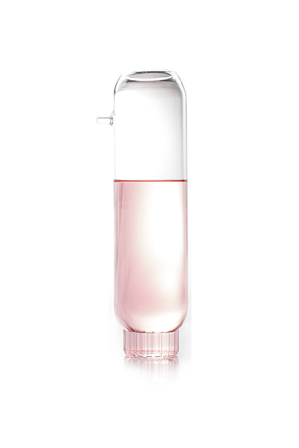 A contemporary glass decanter filled with wine by designer Felicia Ferrone. 