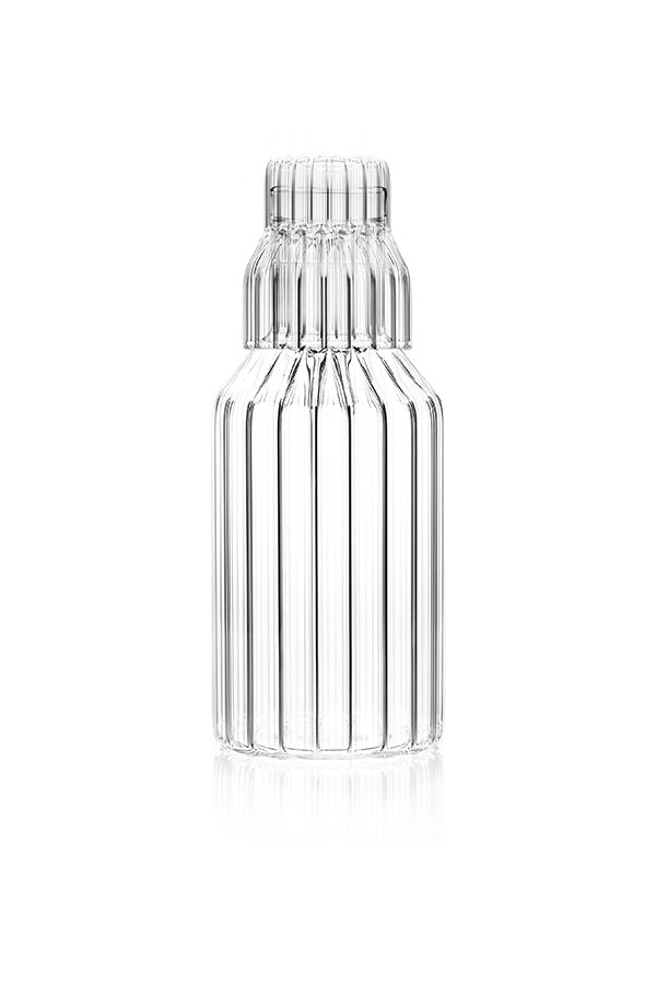 A handmade, fluted glass carafe by contemporary designer with small fluted glass. 