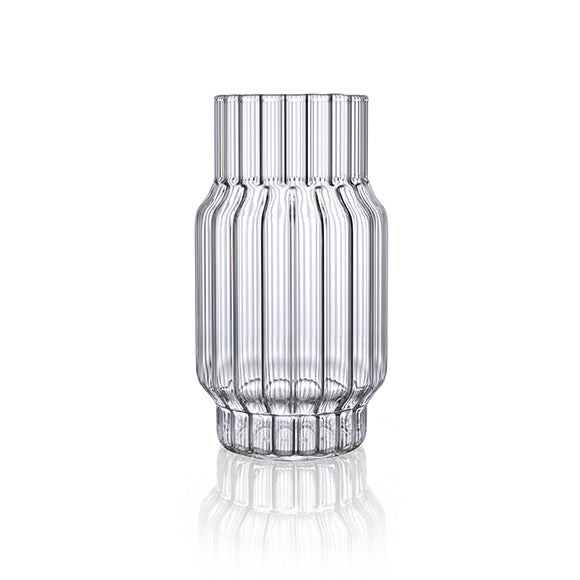 Clear, fluted vase in glass for flowers in home decor. 