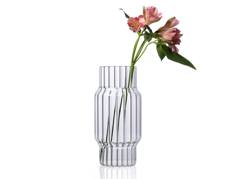 Clear, large, fluted glass vase with flower for home decor. 