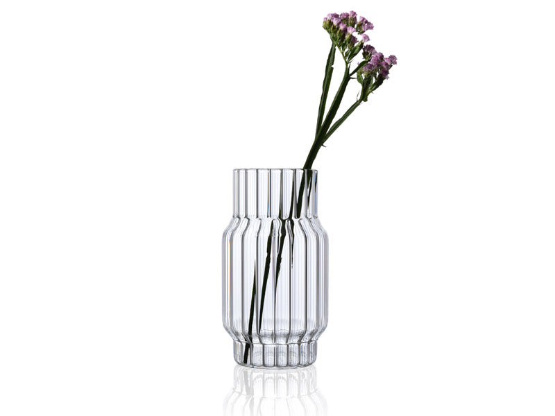 Clear, fluted, glass vase with flower for home decor.