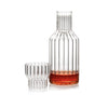 A modern, designer decanter or bedside carafe in fluted glass with a small fluted drinking glass. Sold as a set. 