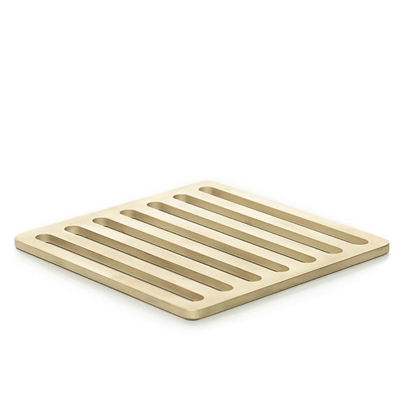 Designer trivet inspired by the streets of Milan, Italy, and made of solid brass with a sandblasted finish. 