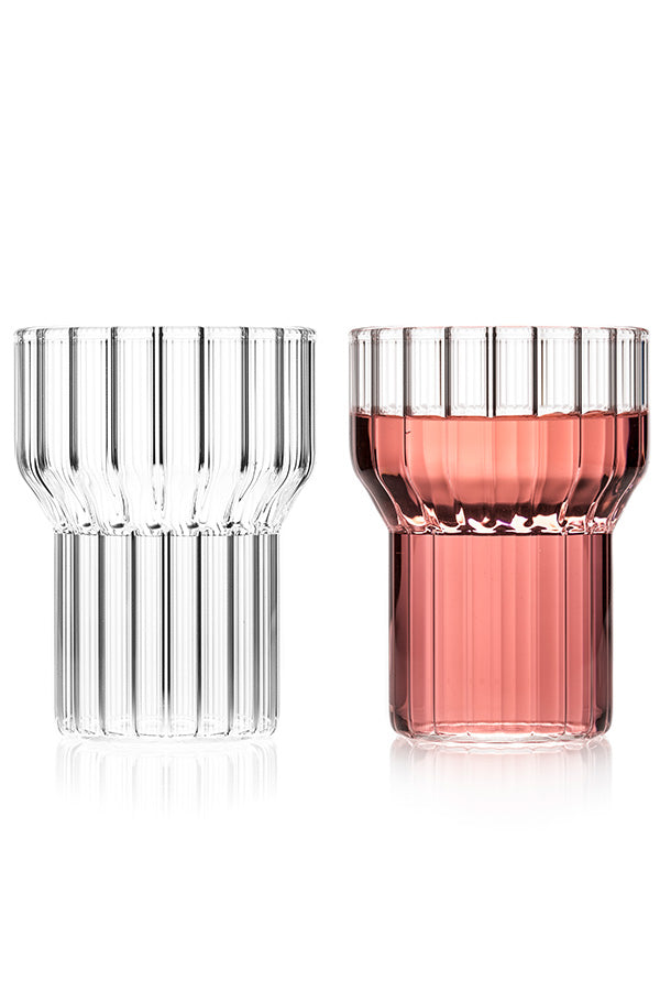 Pair of contemporary, fluted glasses. One glass is clear and the other contains a pink wine. 