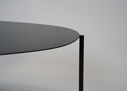 Close up of designer black metal table for contemporary living space. 