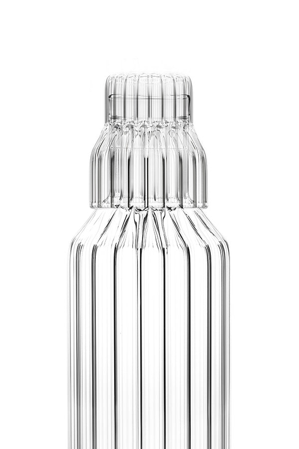 Close up of the small fluted glass that fits on top of the fluted glass bedside table carafe. 
