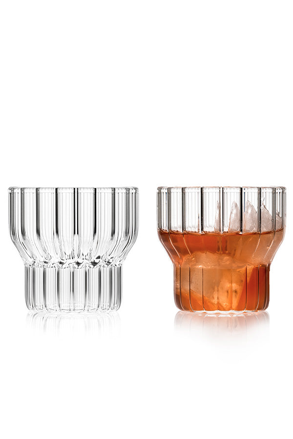 A pair of low, fluted, designer drinking glasses. 